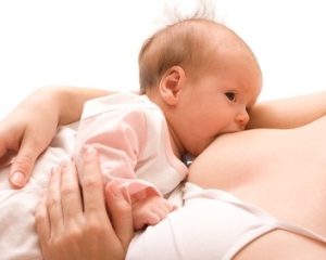 Breastfeeding. Young mother and 1.5 month baby